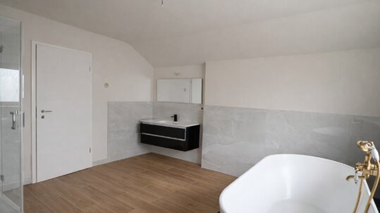 Großzügiges Badezimmer mit freistehender Badewanne und separater Dusche